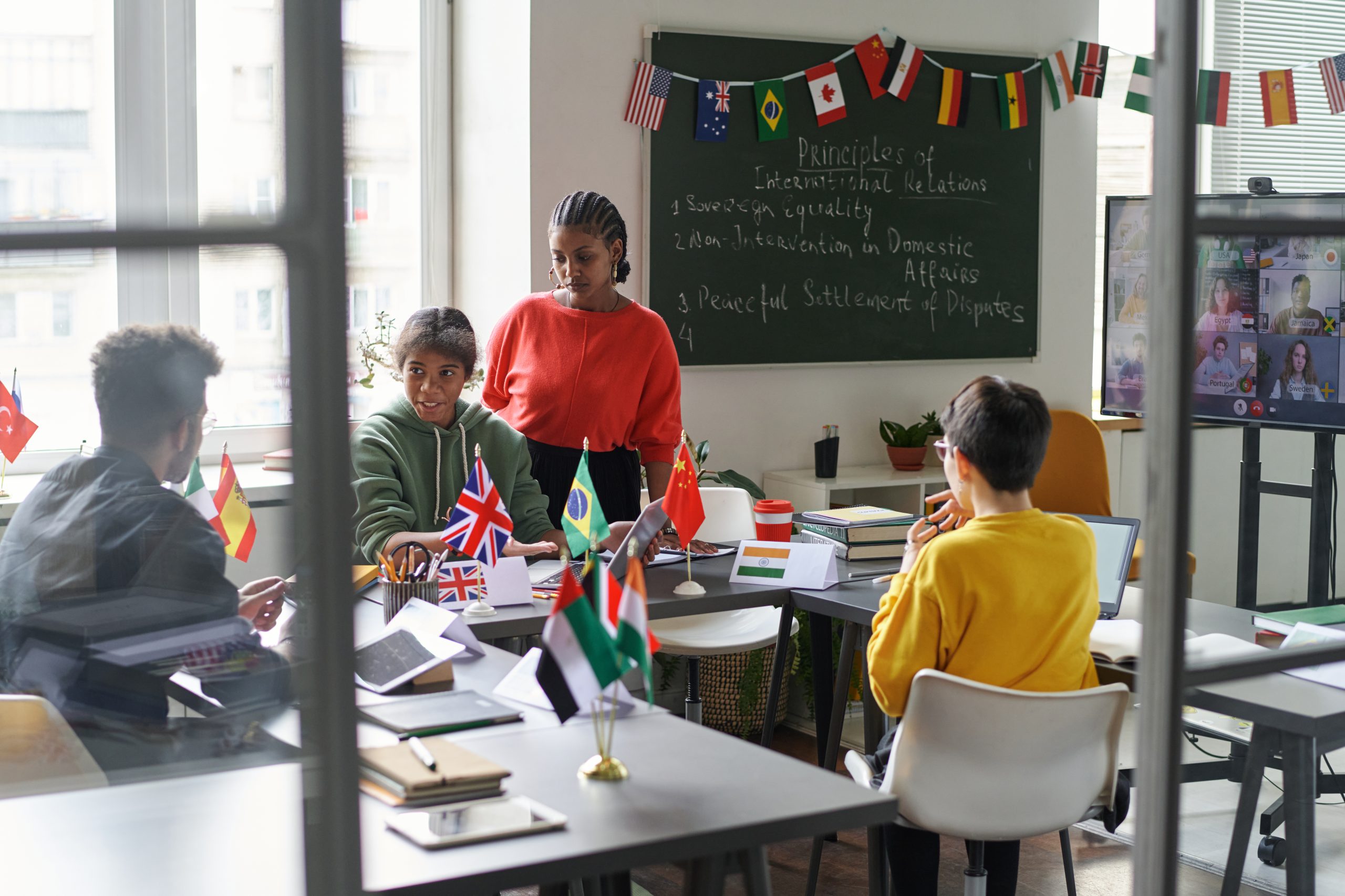 Students talking to teacher in the classroom