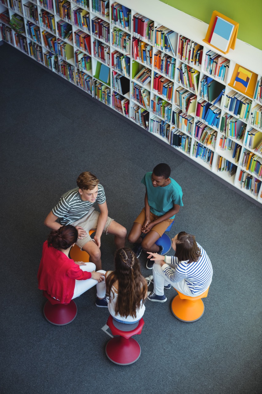 Students interacting with each other in library
